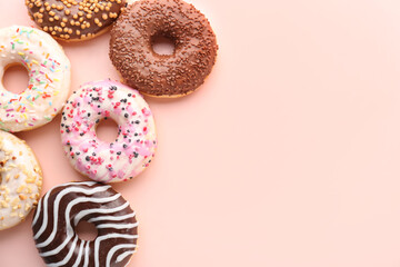 Different sweet donuts on pink background