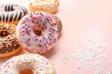 Fototapeta na wymiar Different tasty donuts on pink background, closeup