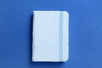 Stylish notebook on blue background
