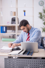 Fototapeta premium Young male employee working in the office