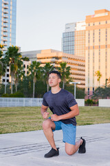 Young muscular man exercising outdoor, city park, downtown, summer. healthy lifestyle concept.