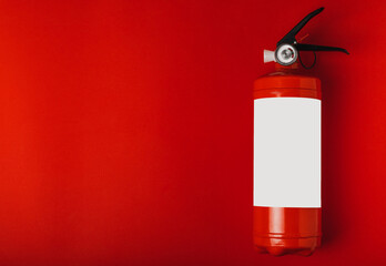 Fire extinguisher on the background of a red wall. Fire protection, home fire extinguisher. home...