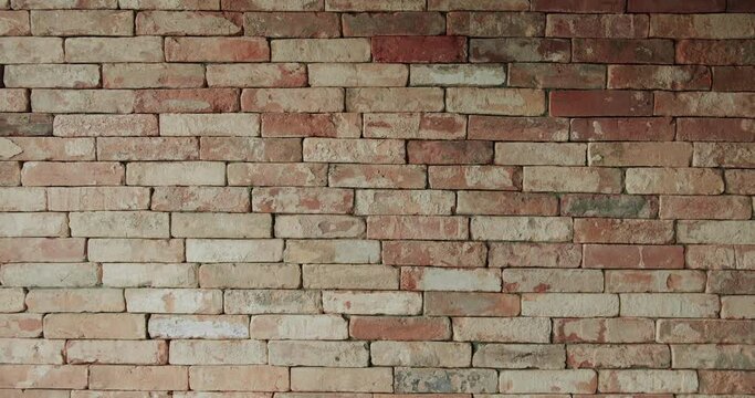 Old brick wall of brown color in a modern apartment, damaged masonry as abstract background composition. Modern interior of loft apartment. brick room, interior texture, wall background.