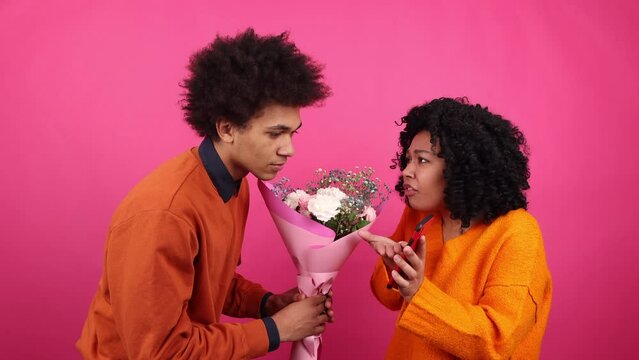 Close-up view of young people having an argument. Betrayed woman arguing with her boyfriend on a Valentine's Day. High quality 4k footage