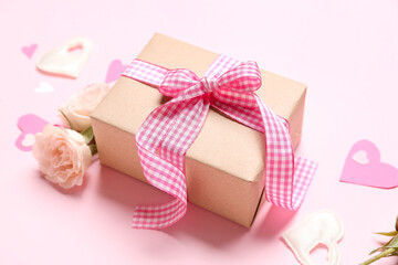 Gift box with roses and hearts for Valentine's Day on pink background, closeup