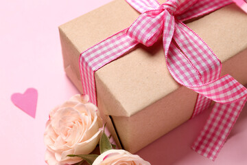 Gift box with roses and hearts for Valentine's Day on pink background, closeup