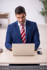 Young male employee working in the office