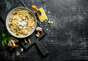 Pasta in bowl with mushrooms, herbs and cheese.