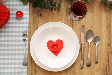 Table setting for Valentine's Day with candles in dining room, top view