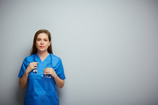 Serious doctor woman in medical suit. Isolated portrait with copy space.