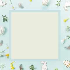 Festive Easter border, frame from easter eggs and spring flower crocus on blue background.