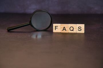 Faq, frequent questions in wooden letters