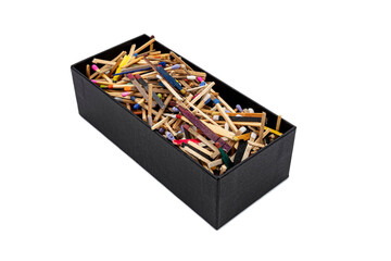 big black cardboard box with matchsticks of various shapes and colors