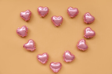 Obraz na płótnie Canvas Heart made of foil balloons on color background. Valentine's Day celebration