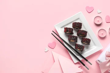 Fotobehang Plate with sushi rolls, chopsticks, candles and hearts on pink background. Valentine's Day celebration © Pixel-Shot