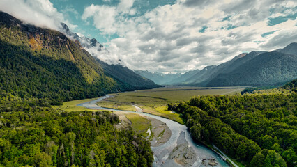 Beautiful Drone Aerial of Vast Lush Green landscape With Mountains, and Streams In Mount Cook National Park, New Zealand
