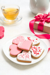 Plate of tasty heart shaped cookies on light background. Valentine's Day celebration