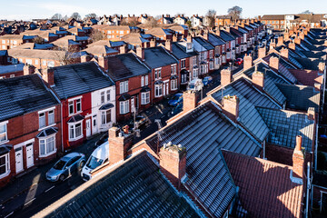 Aerial view of a row of terraced back to back houses with frost on roof