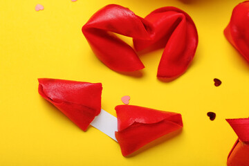 Red fortune cookies on yellow background. Valentine's Day celebration