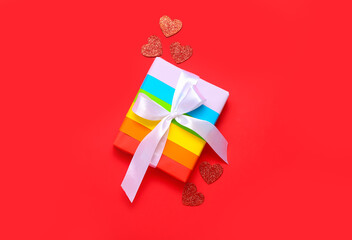 Gift with hearts for Valentine's Day on red background. LGBT concept