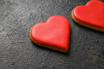 Obraz premium Sweet heart shaped cookies on dark background, closeup. Valentines Day celebration