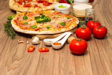 Two different pizza with ingredients on rustic background. Pepperoni pizza and pizza Capricciosa with mozzarella cheese, ham, tomato sauce, salami, mushroom, pepper, spices and fresh basil