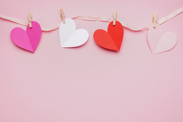 Composition with paper hearts on pink background. Valentines Day celebration