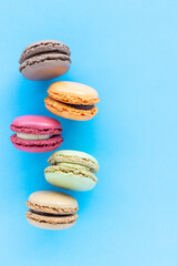 Colorful Macaron Cookies on Blue Background