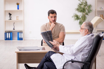 Young male patient visiting old male doctor radiologist