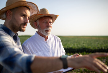 Agronomist and farmer talking in field