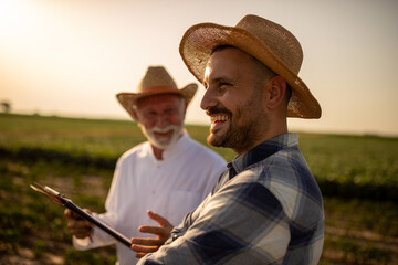 Agronomist and farmer talking in field