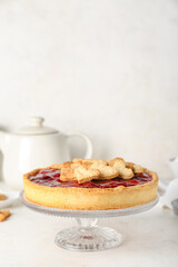 Stand with sweet strawberry pie and cookie hearts for Valentine's day on white table