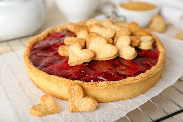 Oven rack with sweet strawberry pie and cookie hearts for Valentine's day on light table