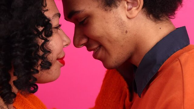 Close-up view of young people kissing on a romantic Valentine's date. Portrait of African American family celebrating anniversary. High quality 4k footage