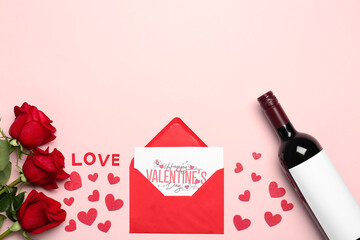 Bottle of wine, envelope, paper hearts, rose flowers and word LOVE on pink background. Valentine's Day celebration