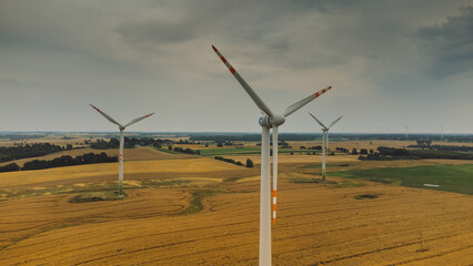 Aerial view of wind turbine. Windmills at harvest time, fields from above.