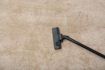 Removing dirt from carpet with modern vacuum cleaner indoors, top view. Space for text