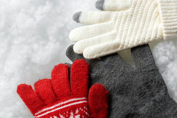 Gloves on a white background. Snowy background. Close up. COPY SPACE.