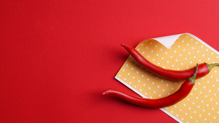 Obraz premium Pepper plasters and chili on red background, flat lay. Space for text
