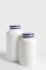 Closed plastic medicine bottles on white background. Medicament