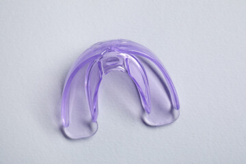 Dental mouth guard on grey background, top view. Bite correction