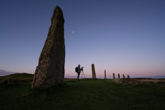 Photographer at Ring of Brodgar standing stones, Orkney, Scotland