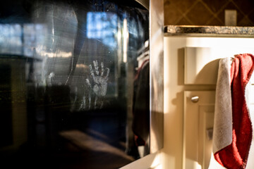 Small Child Handprint on Oven Door in Kitchen