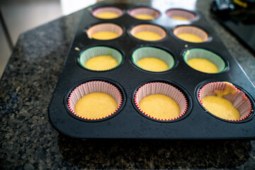 Cupcake Batter in Colored Liners on Countertop