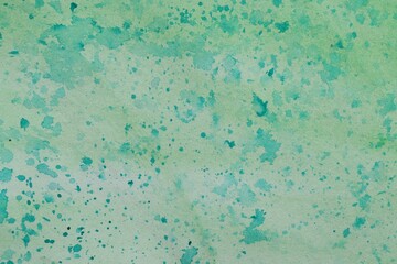 Abstract watercolor painting with green blots as background, top view