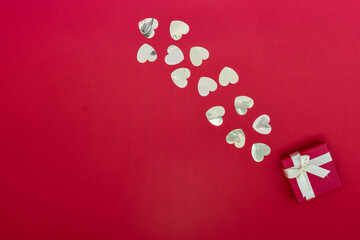 Hearts of paper on red textured background. San Valentine day concept.