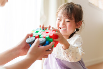 Obraz na płótnie Canvas おもちゃで遊ぶ女の子とお母さん