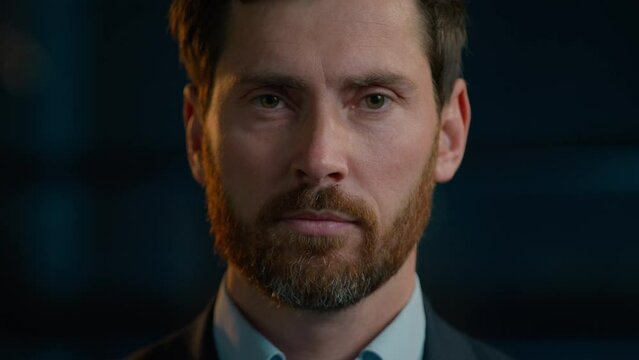 Business portrait serious Caucasian man adult male posing in evening office looking at camera close-up headshot sad face middle-aged 40s bearded businessman agent boss employee worker standing indoors