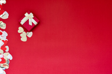 Hearts of paper on red textured background. San Valentine day concept.
