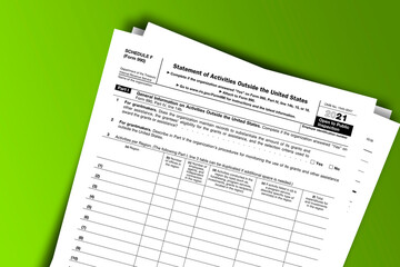 Obraz premium Form 990 (Schedule F) documentation published IRS USA 11.15.2021. American tax document on colored
